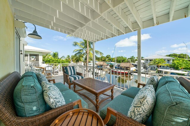 balcony with a water view and an outdoor hangout area