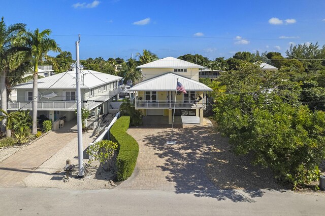 view of front of house featuring a garage and a balcony