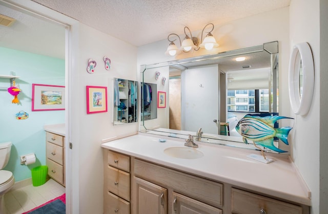 83201 Old Hwy Unit 409, Islamorada, FL 33036 - bathroom with a textured ceiling, toilet, vanity, and tile patterned floors