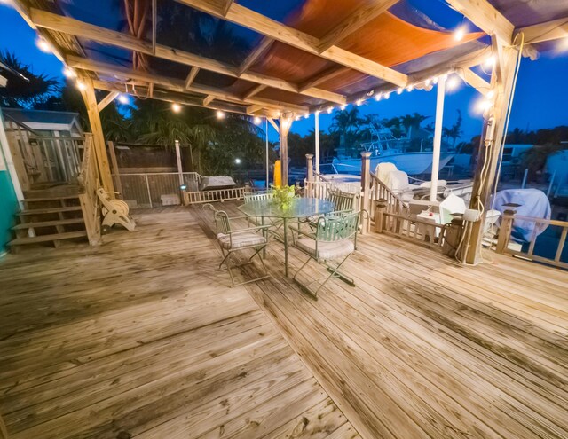 deck at twilight featuring outdoor dining space