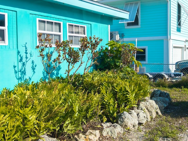 view of home's exterior with fence