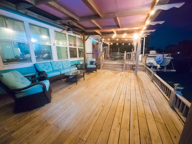 deck at twilight featuring an outdoor living space and ceiling fan