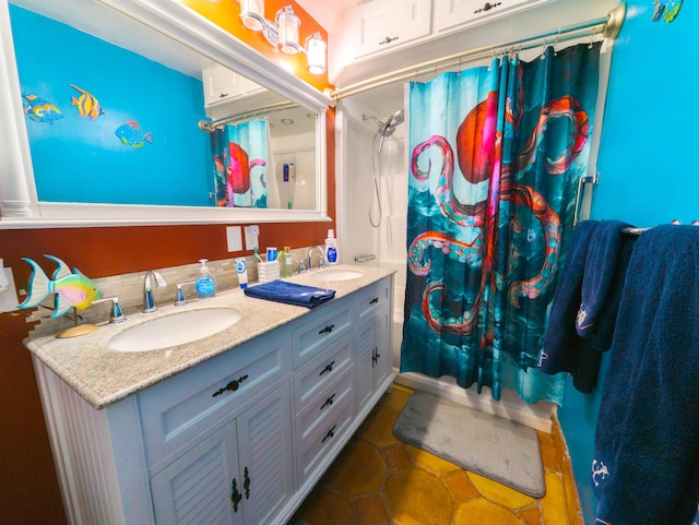 bathroom featuring double vanity, shower / bath combo with shower curtain, and a sink