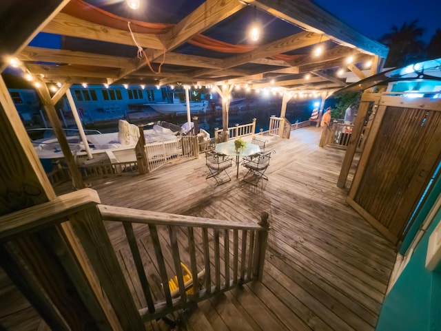 deck at twilight featuring outdoor dining space