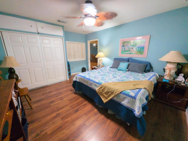 bedroom featuring a closet, visible vents, ceiling fan, and wood finished floors