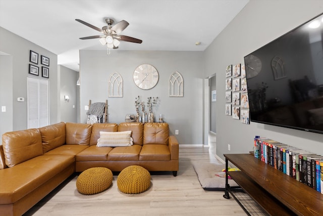 living room featuring ceiling fan and light wood-type flooring