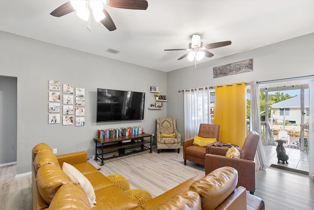 living room featuring hardwood / wood-style floors and ceiling fan