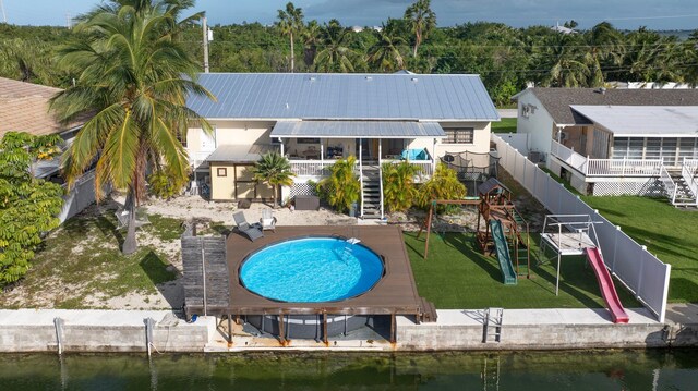 back of house featuring a fenced in pool and a water view