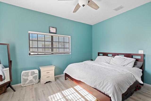 bedroom with ceiling fan and light hardwood / wood-style floors