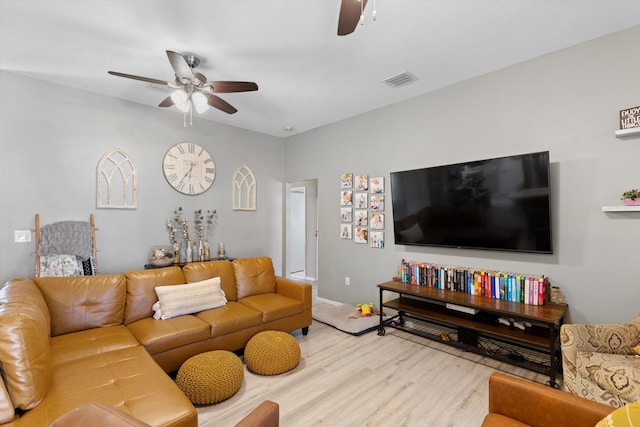 living room with ceiling fan and light wood-type flooring