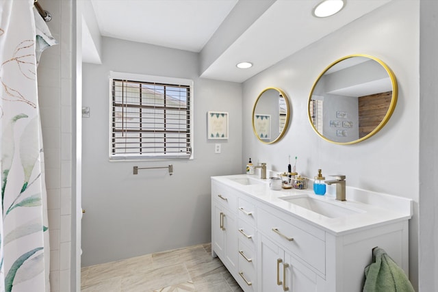 bathroom featuring vanity and curtained shower