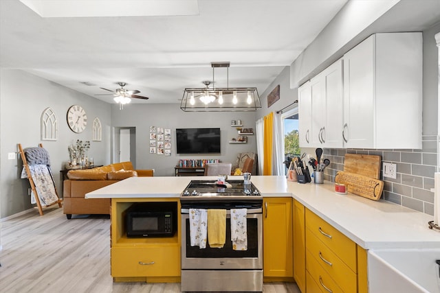 kitchen with stainless steel range with electric cooktop, hanging light fixtures, backsplash, kitchen peninsula, and white cabinets