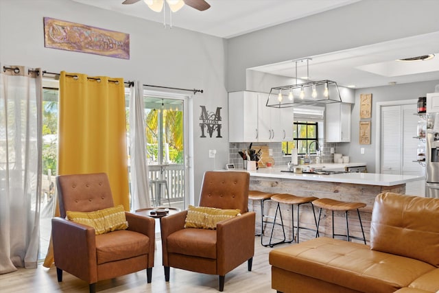 kitchen featuring pendant lighting, kitchen peninsula, and white cabinets