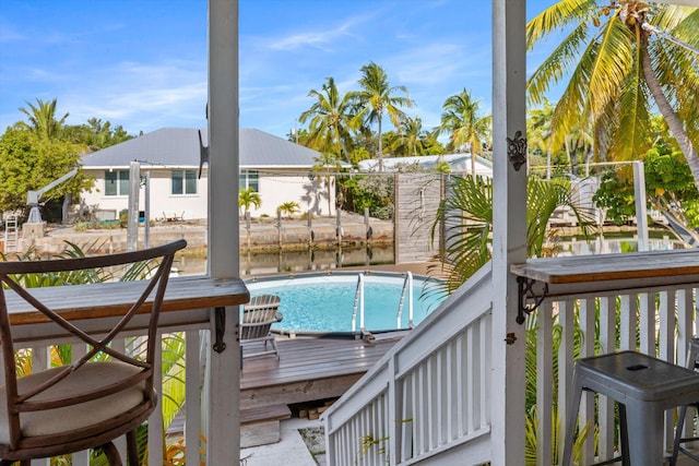 view of swimming pool featuring a deck with water view