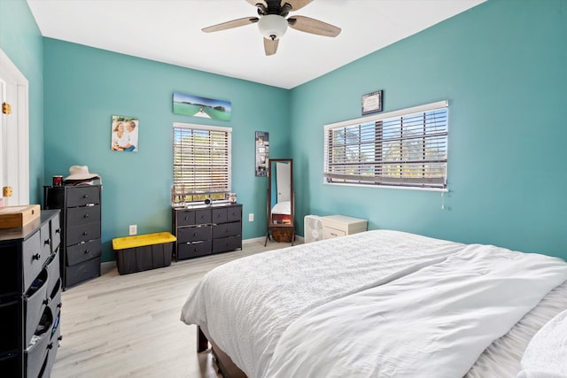 bedroom with light hardwood / wood-style floors and ceiling fan