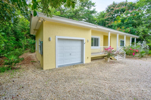 single story home with a garage and covered porch