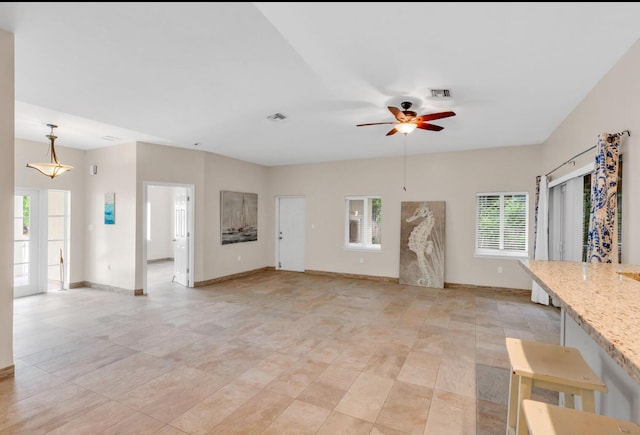 unfurnished living room with ceiling fan