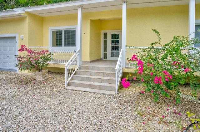 property entrance with a garage and covered porch