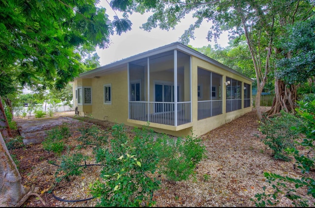 view of side of home featuring a sunroom