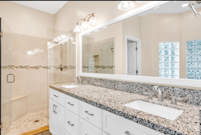 bathroom with vanity and a shower with door