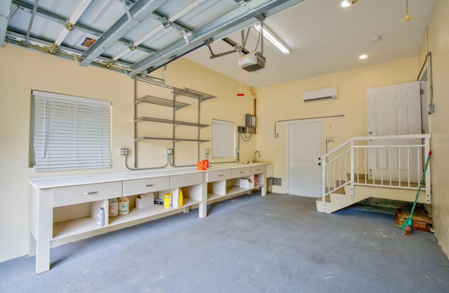 garage featuring a garage door opener and a wall mounted AC