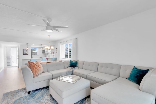 389 N Anglers Dr Unit 101, Marathon, FL 33050 - living room with a chandelier, a ceiling fan, wood finished floors, and baseboards