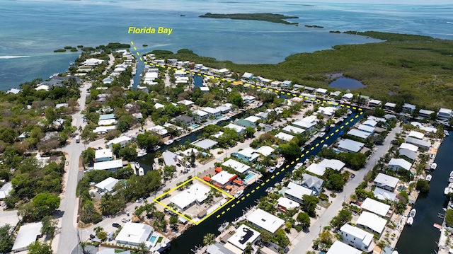 214 Pueblo St, Tavernier, FL 33070 - aerial perspective of suburban area with a large body of water and property parcel outlined
