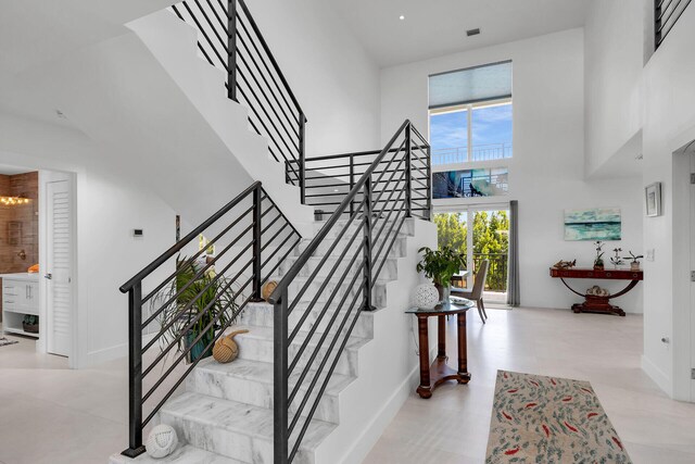 staircase with a towering ceiling