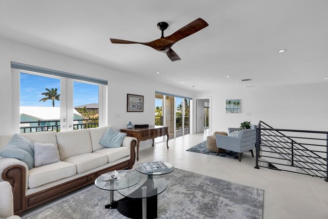 living room featuring a healthy amount of sunlight, ceiling fan, and french doors