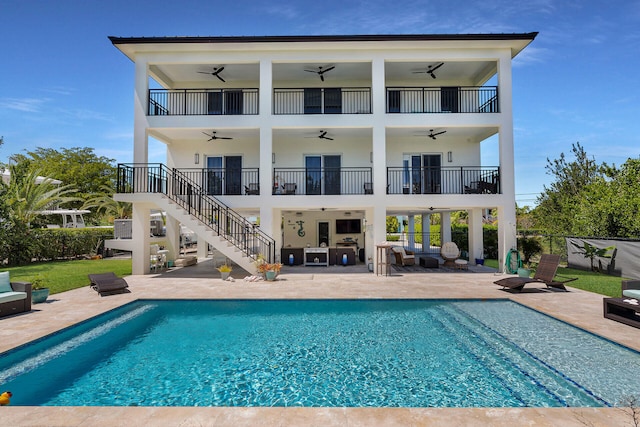 rear view of house featuring a patio, outdoor lounge area, and ceiling fan