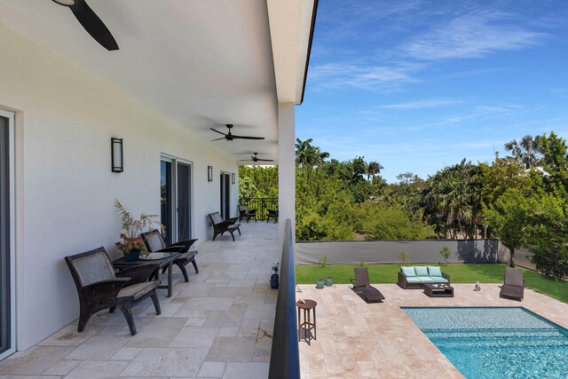 view of swimming pool featuring ceiling fan, an outdoor living space, and a patio