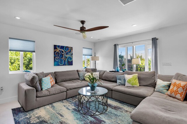 living room with a healthy amount of sunlight and ceiling fan