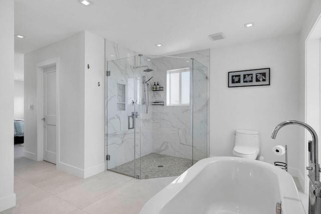 bathroom featuring toilet and a shower with door