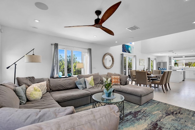 living room featuring tile patterned flooring and ceiling fan