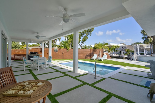 view of pool with a grill, ceiling fan, and a patio area