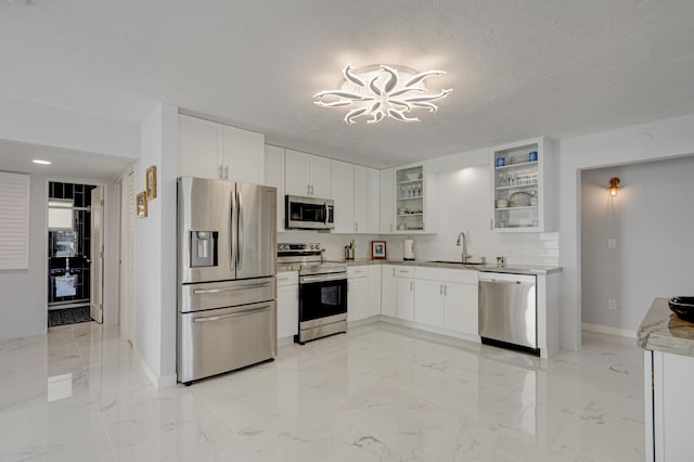 kitchen featuring stainless steel appliances, sink, a textured ceiling, and white cabinets