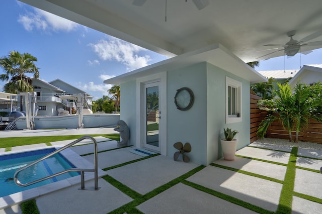 view of patio / terrace with a fenced in pool and ceiling fan