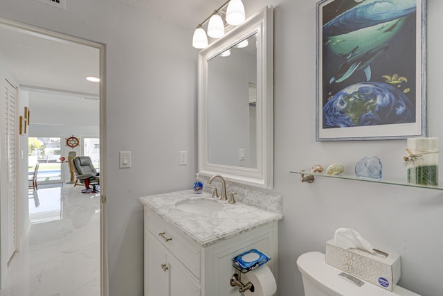 bathroom featuring vanity and toilet