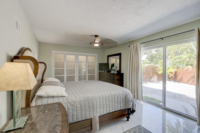 bedroom with french doors, ceiling fan, a textured ceiling, and access to outside