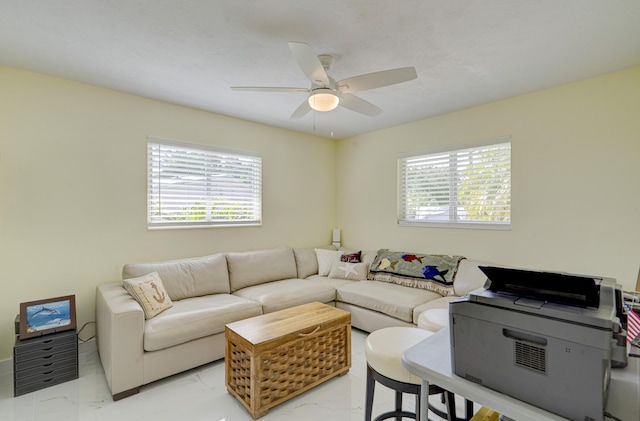 living room featuring plenty of natural light and ceiling fan