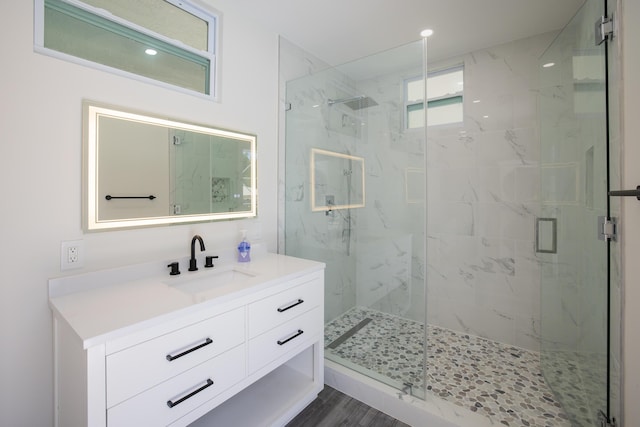 bathroom with vanity, wood-type flooring, and walk in shower