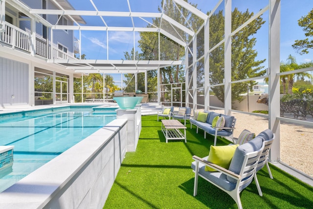 view of swimming pool with a patio, a lanai, outdoor lounge area, and a lawn