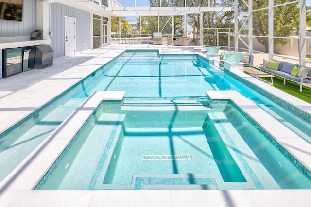 view of swimming pool with an in ground hot tub, a patio, and glass enclosure