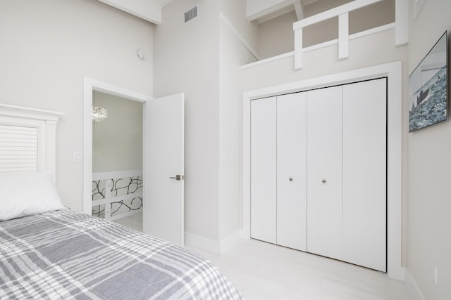 unfurnished bedroom featuring a closet and a high ceiling