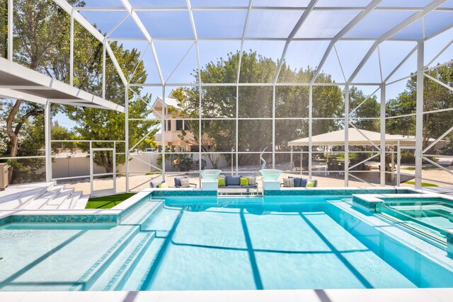 view of swimming pool featuring a patio and glass enclosure