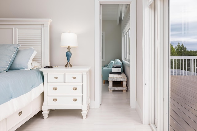 bedroom with access to outside and light hardwood / wood-style floors