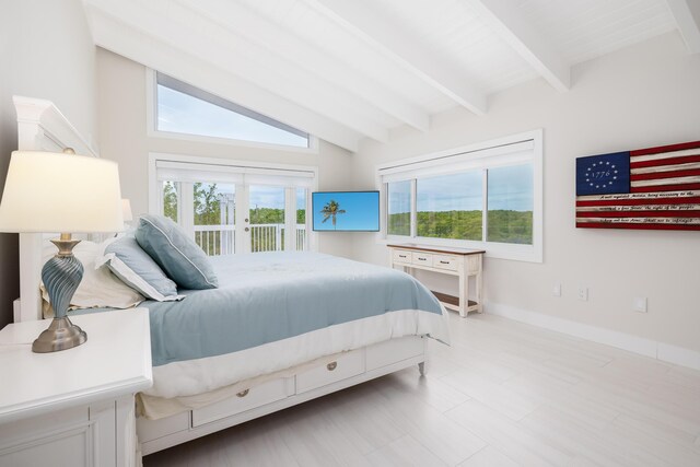 bedroom featuring vaulted ceiling with beams and access to outside