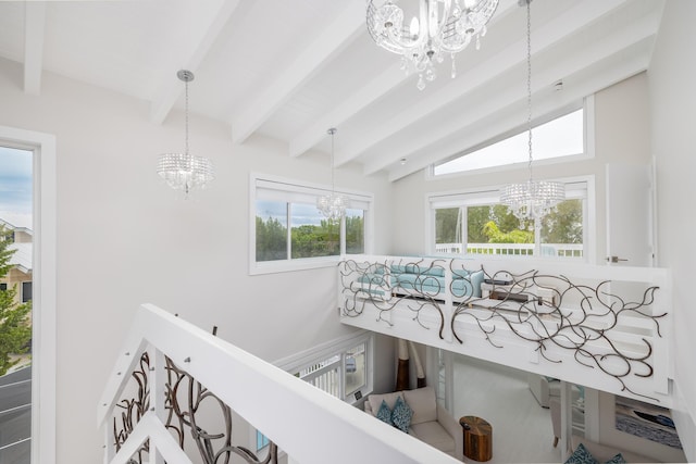 interior space with beamed ceiling and an inviting chandelier