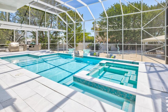 view of pool with area for grilling, a lanai, a patio, and an in ground hot tub