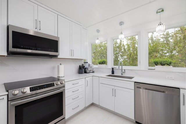 kitchen with white cabinetry, appliances with stainless steel finishes, and sink